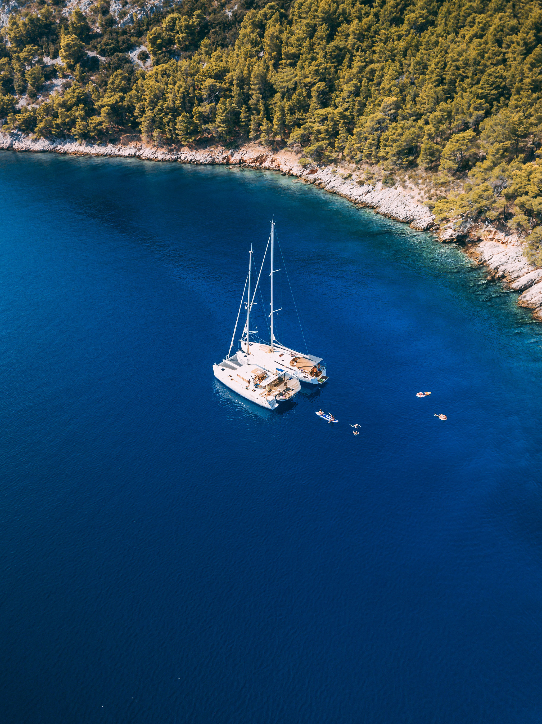 Aerial view of Hvar old town with red rooftops and turquoise Adriatic Sea