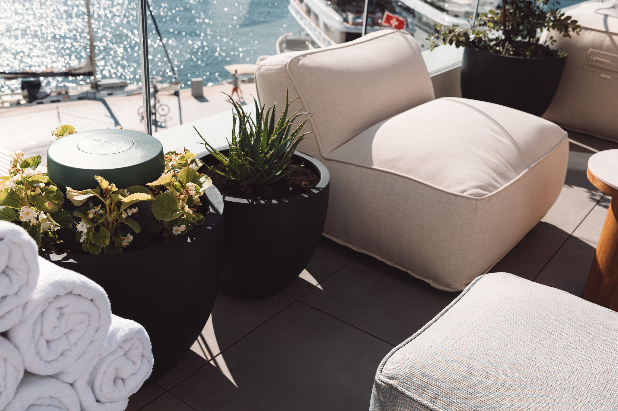 Bose outdoor speaker integrated into planter with yacht harbor view at hotel terrace