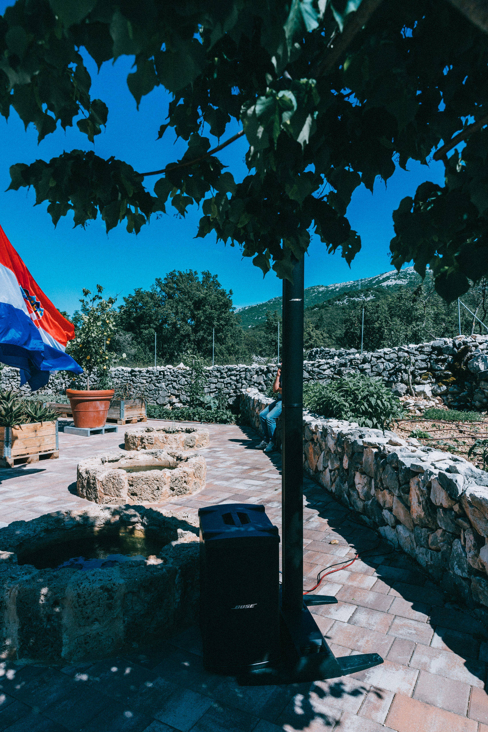 Discreet Bose speaker installation in a Dalmatian stone courtyard villa