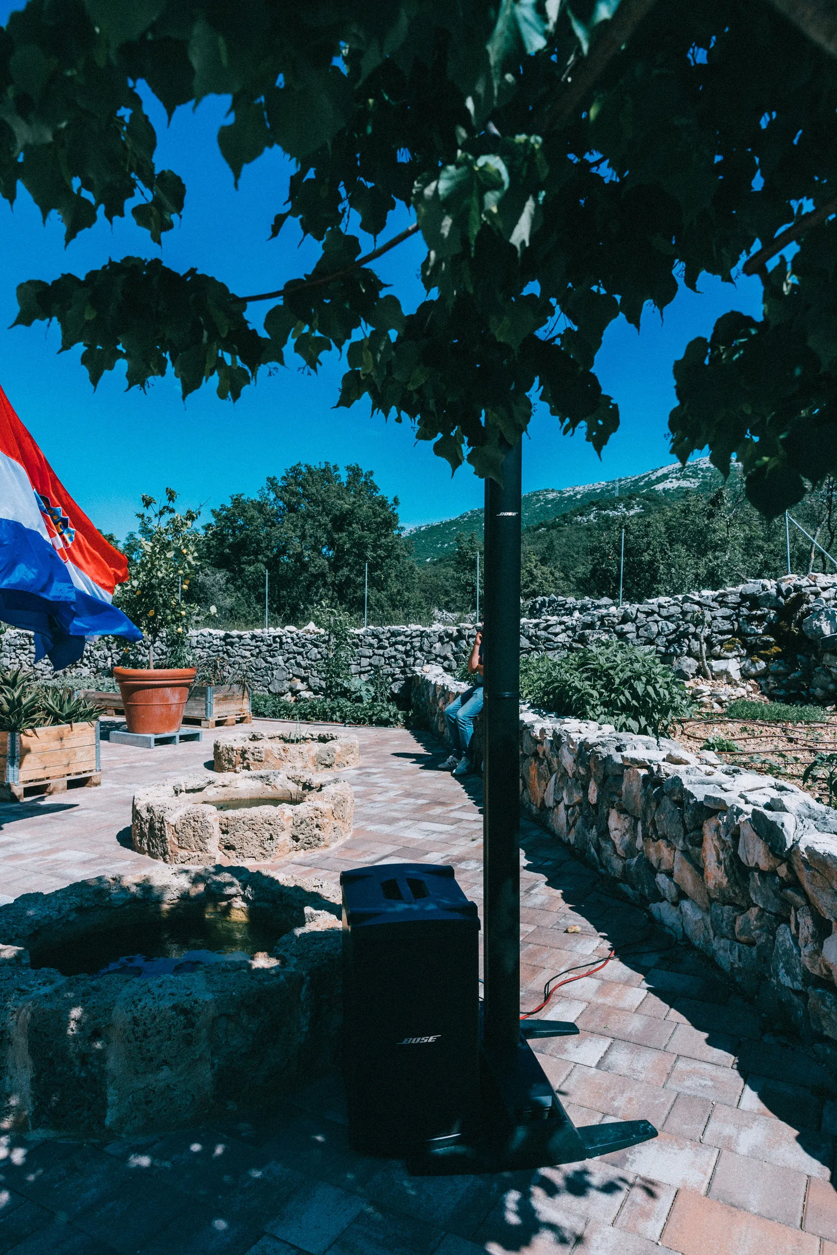 Bose speaker in Dalmatian stone courtyard villa installation — Cosmic Production