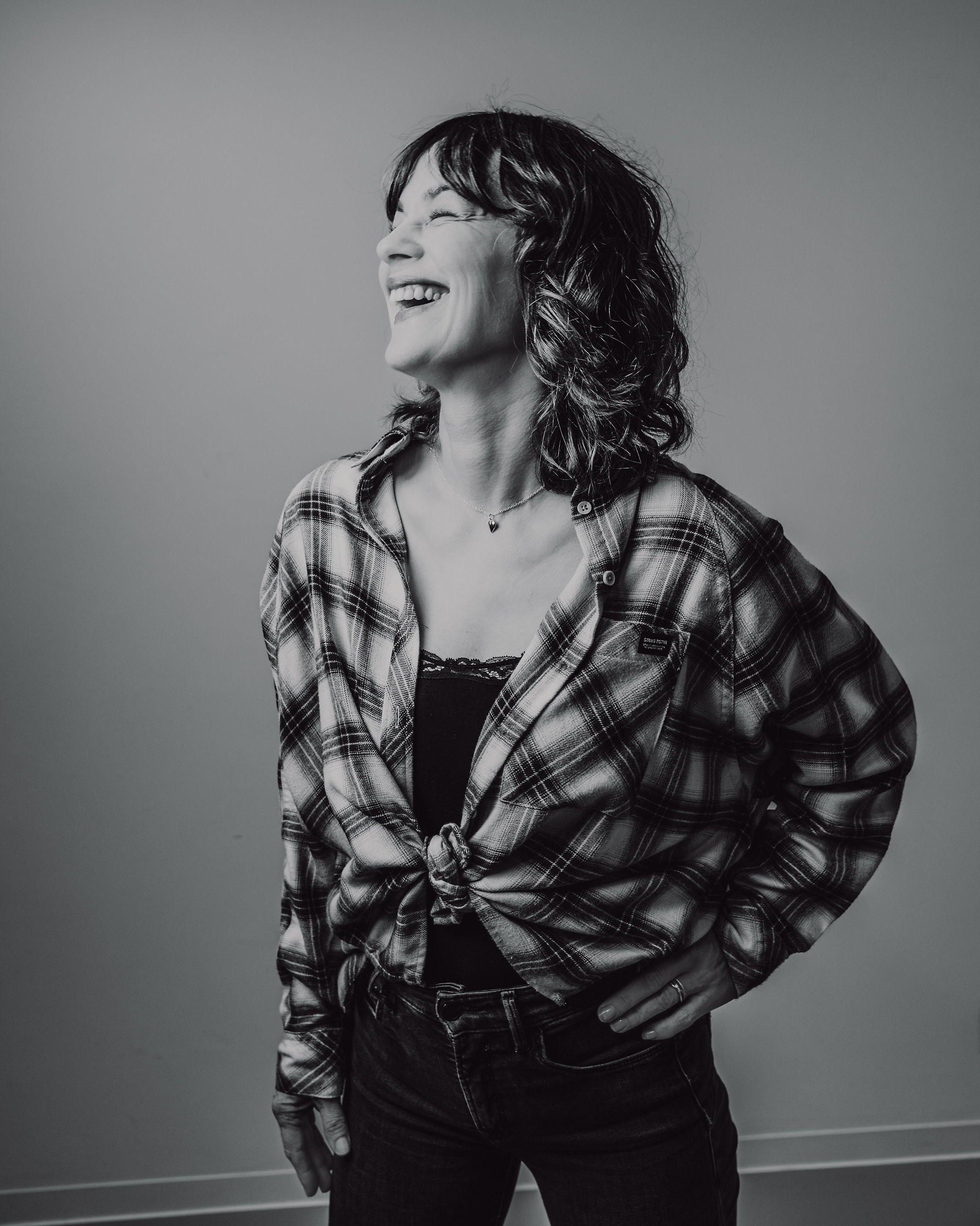 DJ K2B laughing portrait in black and white, energy and joy at Cosmic Production masterclass