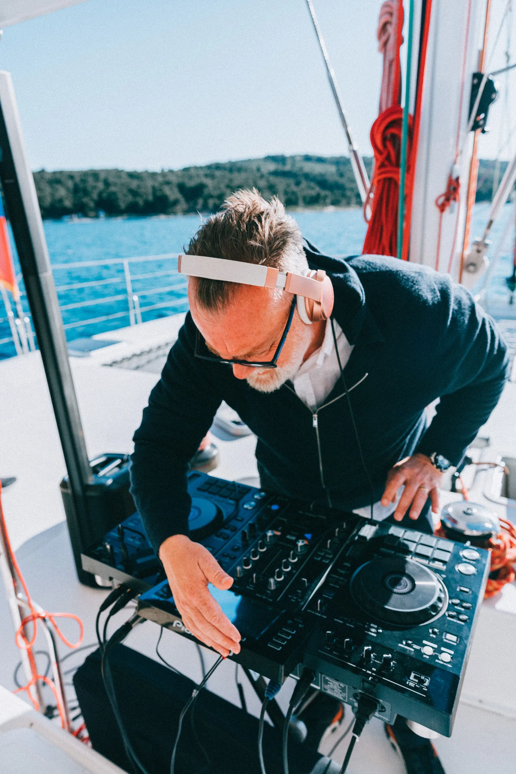 DJ Matthew Bee performing on a yacht with Pioneer DJ equipment on the Adriatic — Cosmic Production corporate event