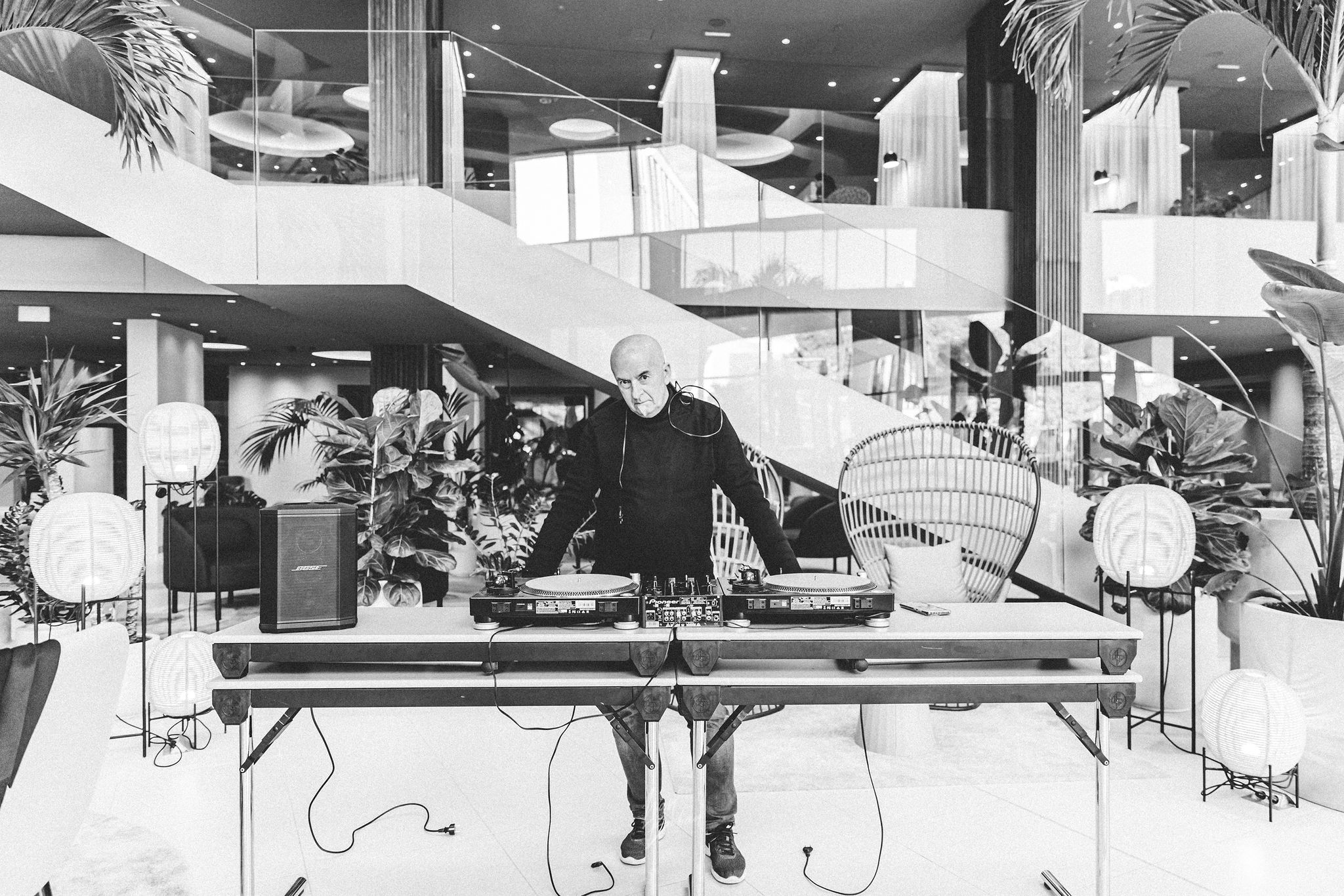 DJ Matthew Bee performing with vinyl turntables and Bose S1 Pro speaker in the modern lobby of Hotel Radisson Blu Split