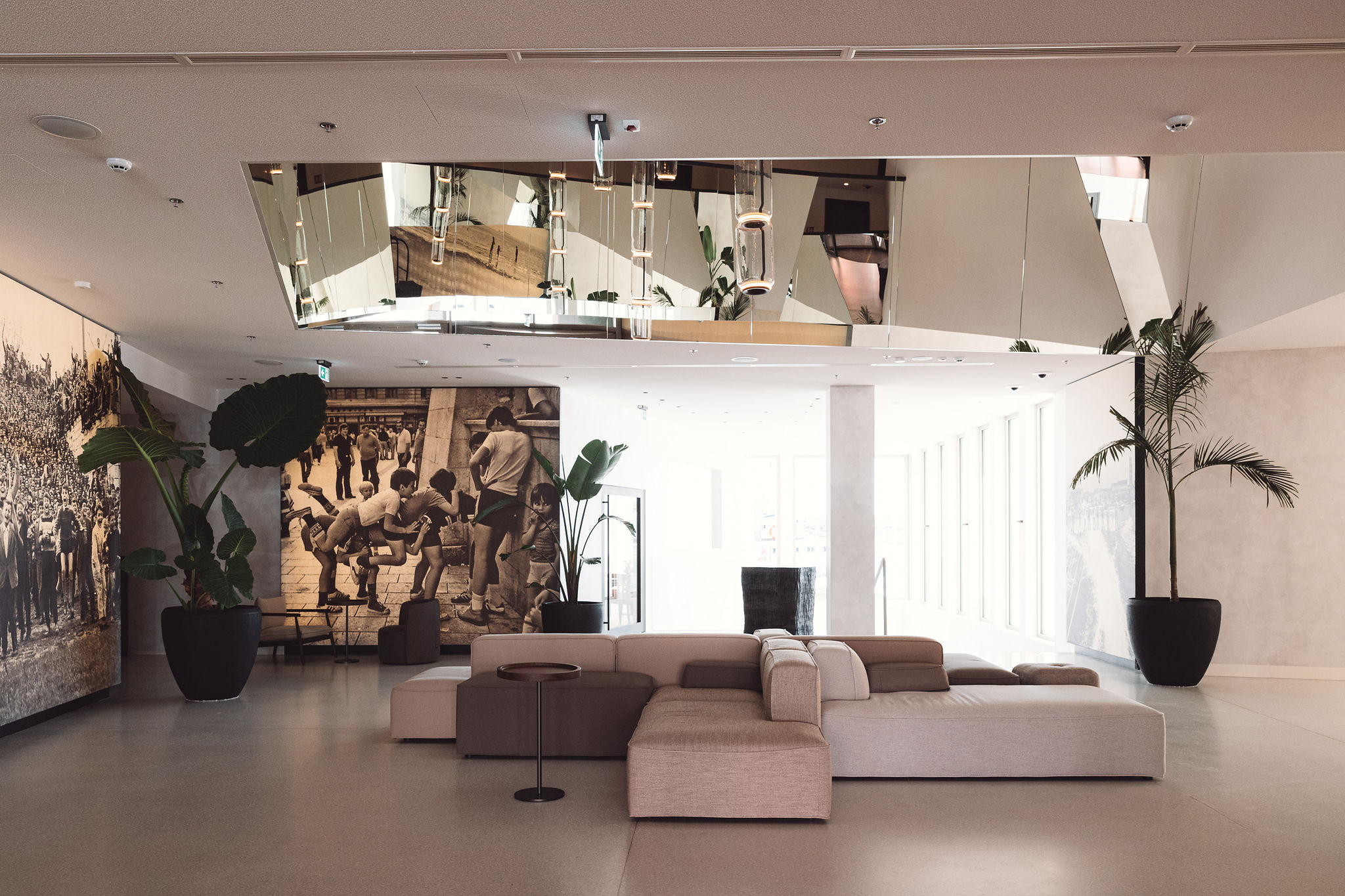 Hotel lobby atrium with black and white murals and Bose speakers installed at Ambassador Hotel