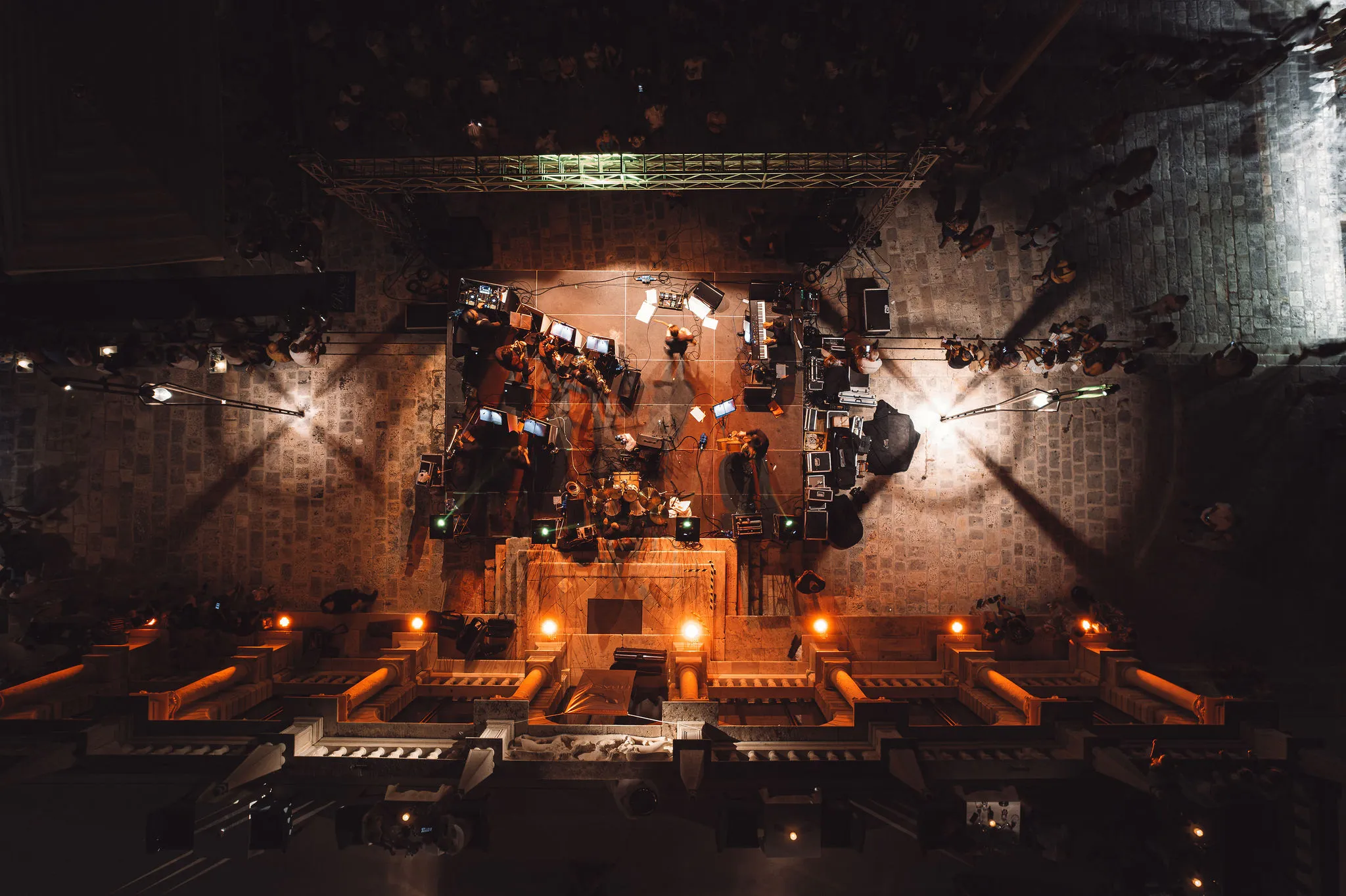 Aerial view of Hvar stage with overhead truss and speakers at a night event