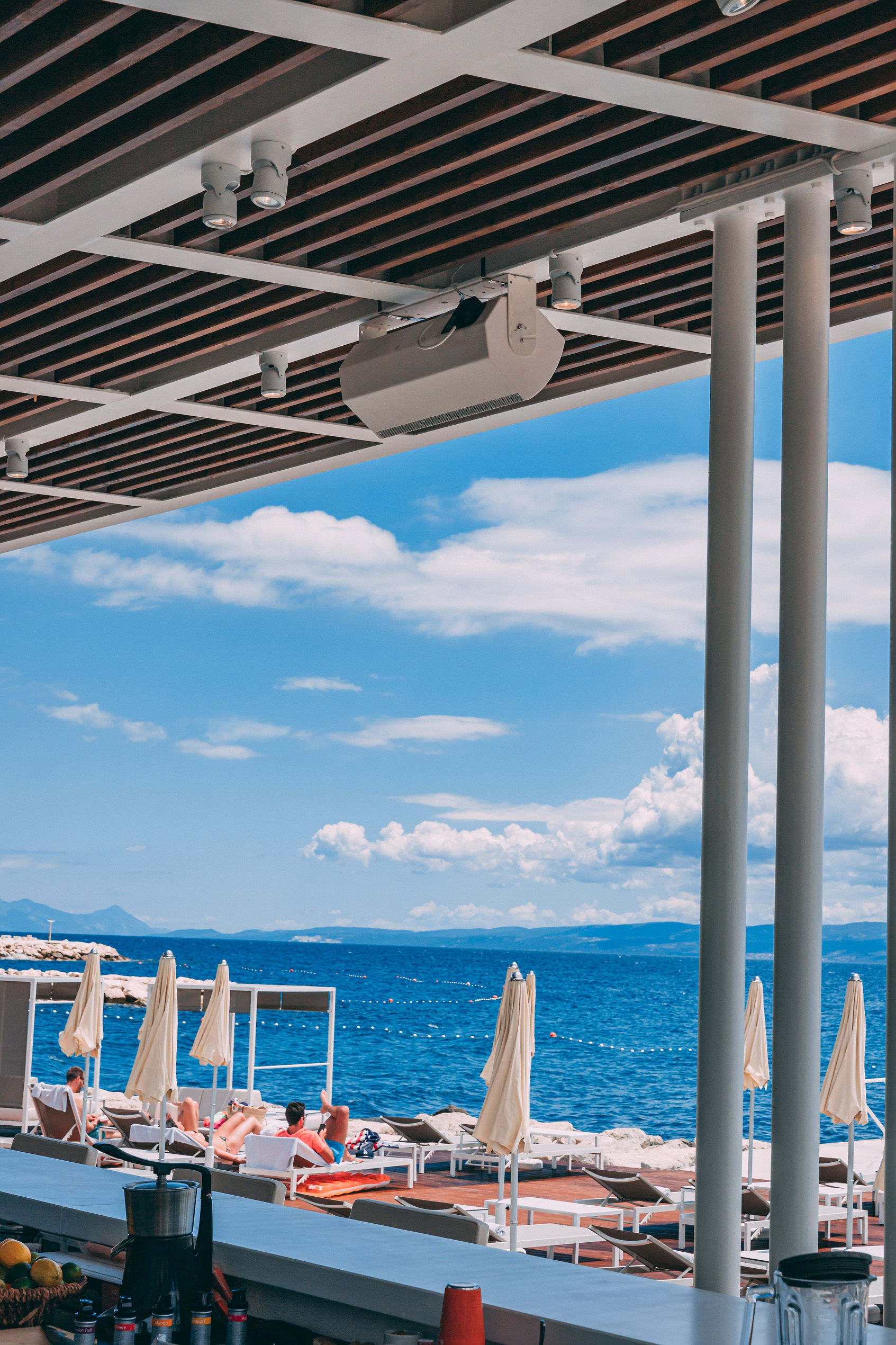 Bose speaker on ceiling at Mistral Beach Bar with Adriatic sea view and sun loungers at Radisson Blu Split