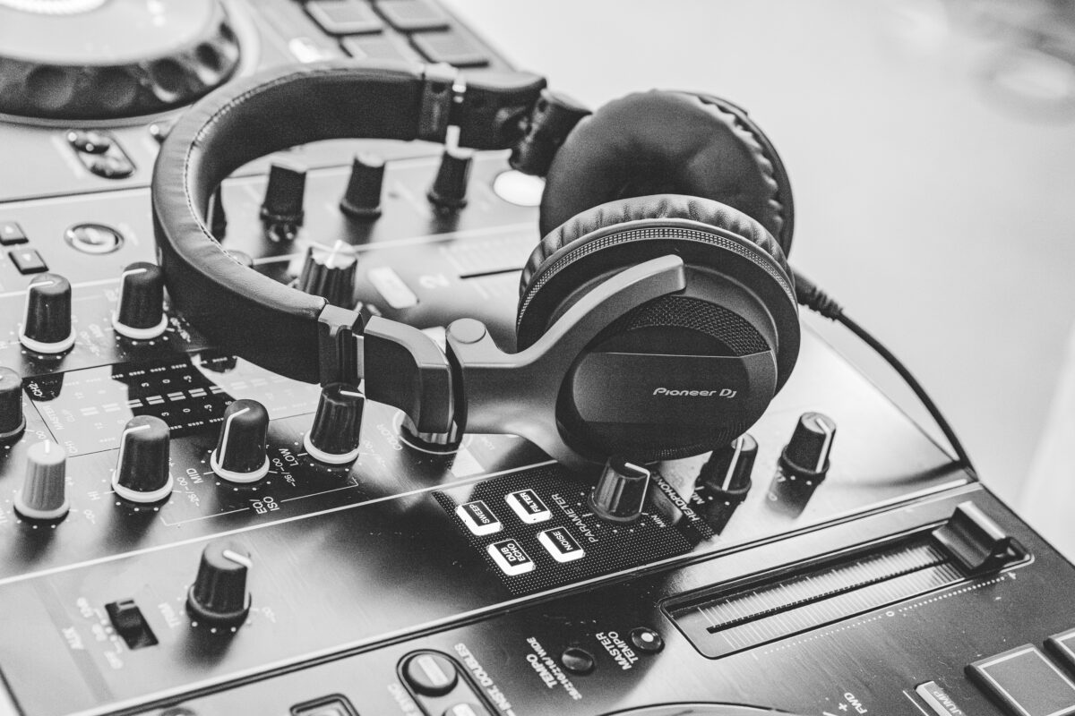Rent a DJ in Croatia How To - Cosmic Production - Closeup shot of DJ's headphones resting on a DJ Mixer